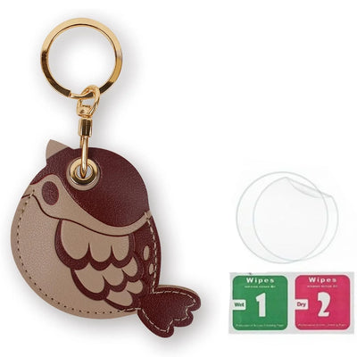 Brown fish-shaped leather AirTag keychain with gold hardware, beige hand straps