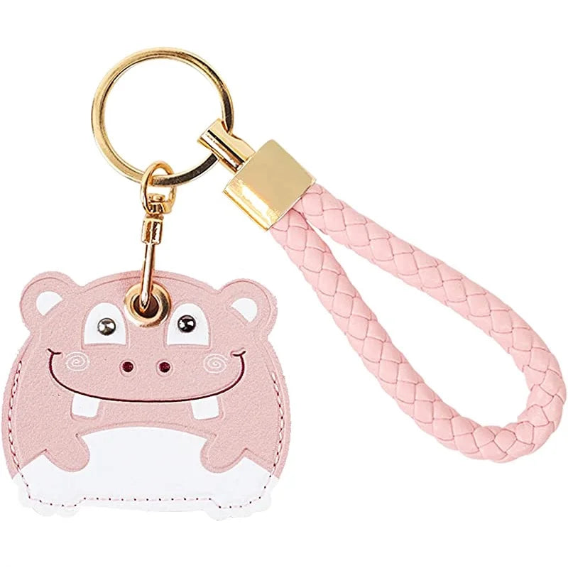 Pink hippo AirTag keychain with woven leather hand straps and gold hardware