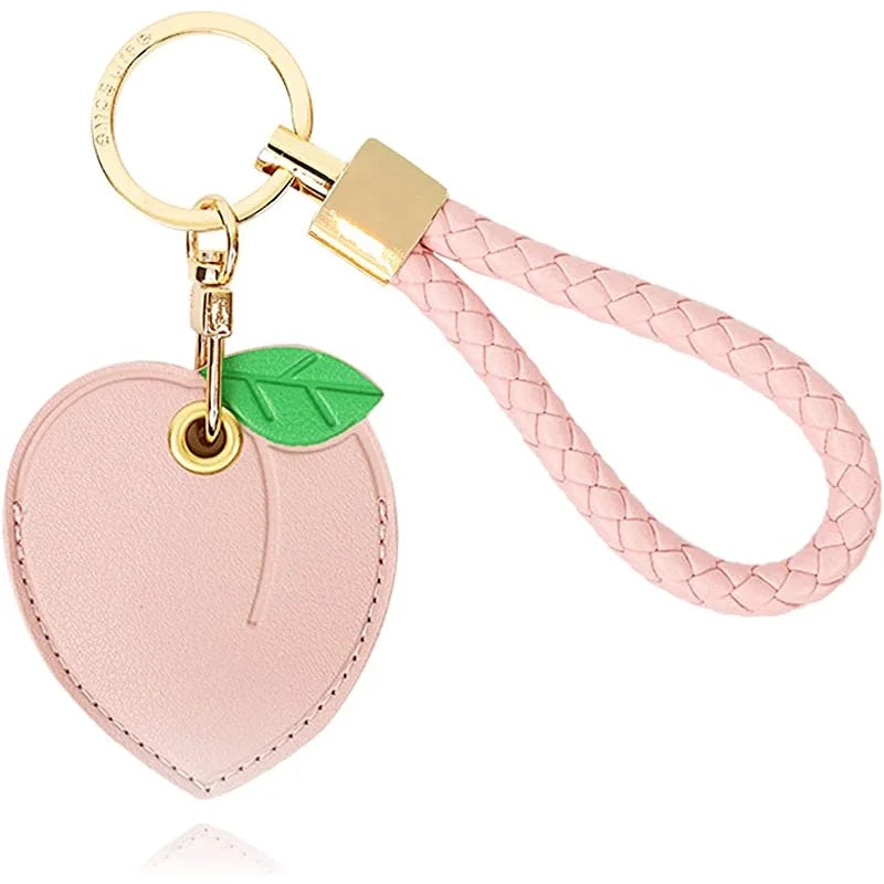 Pink peach AirTag leather keychain with hand straps and green leaf charm