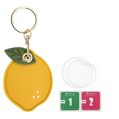Yellow lemon keychain with green leaves, gold ring, and hand straps for AirTag