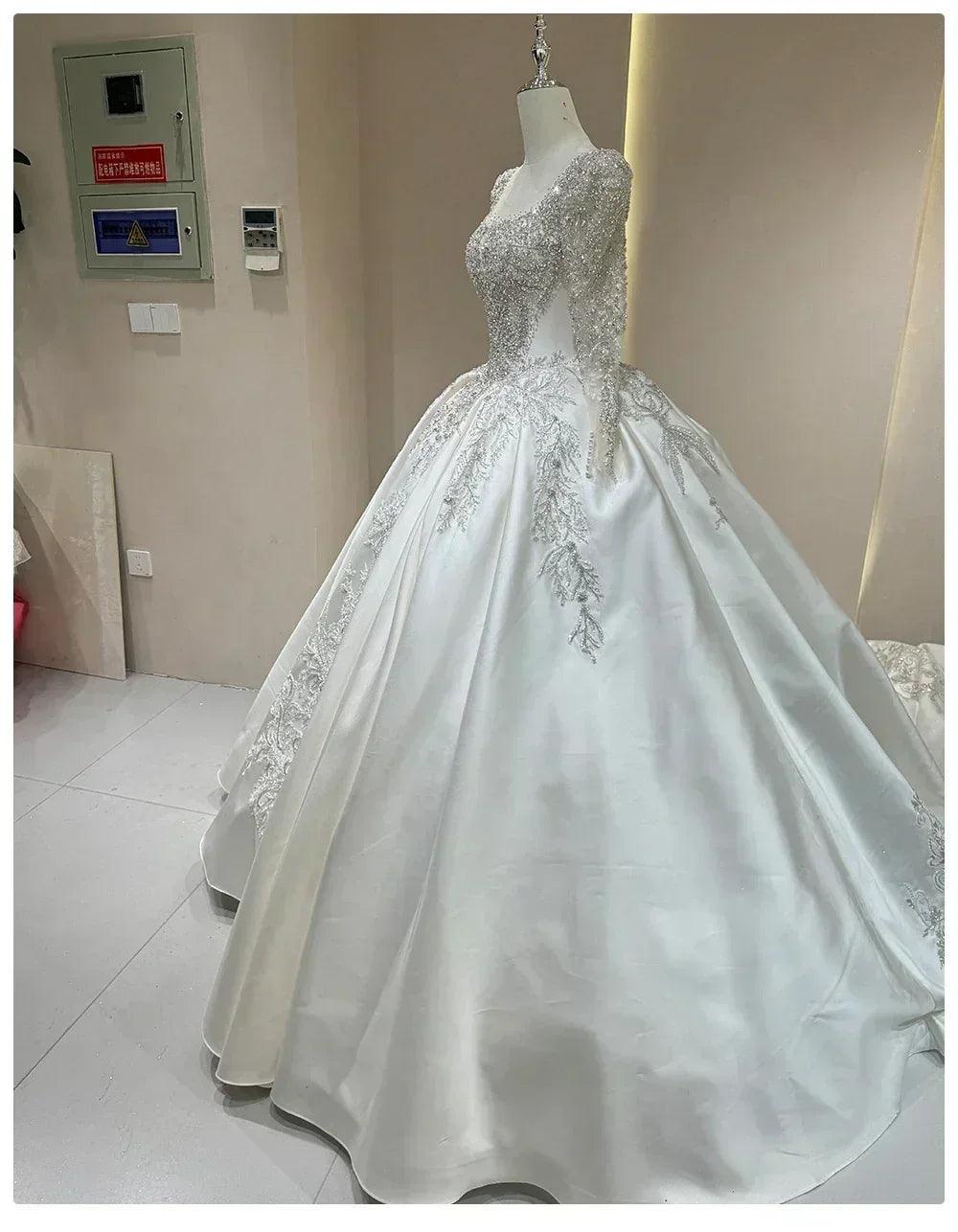 Wedding dress with sparkling embellishments and long trains delicate lace