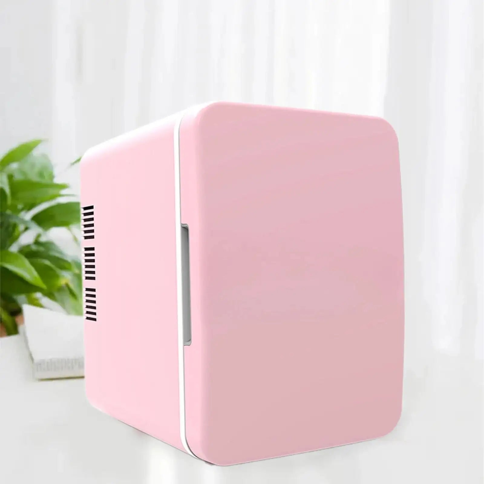 Pink mini fridge with white vent and handle, compact design for personal use.